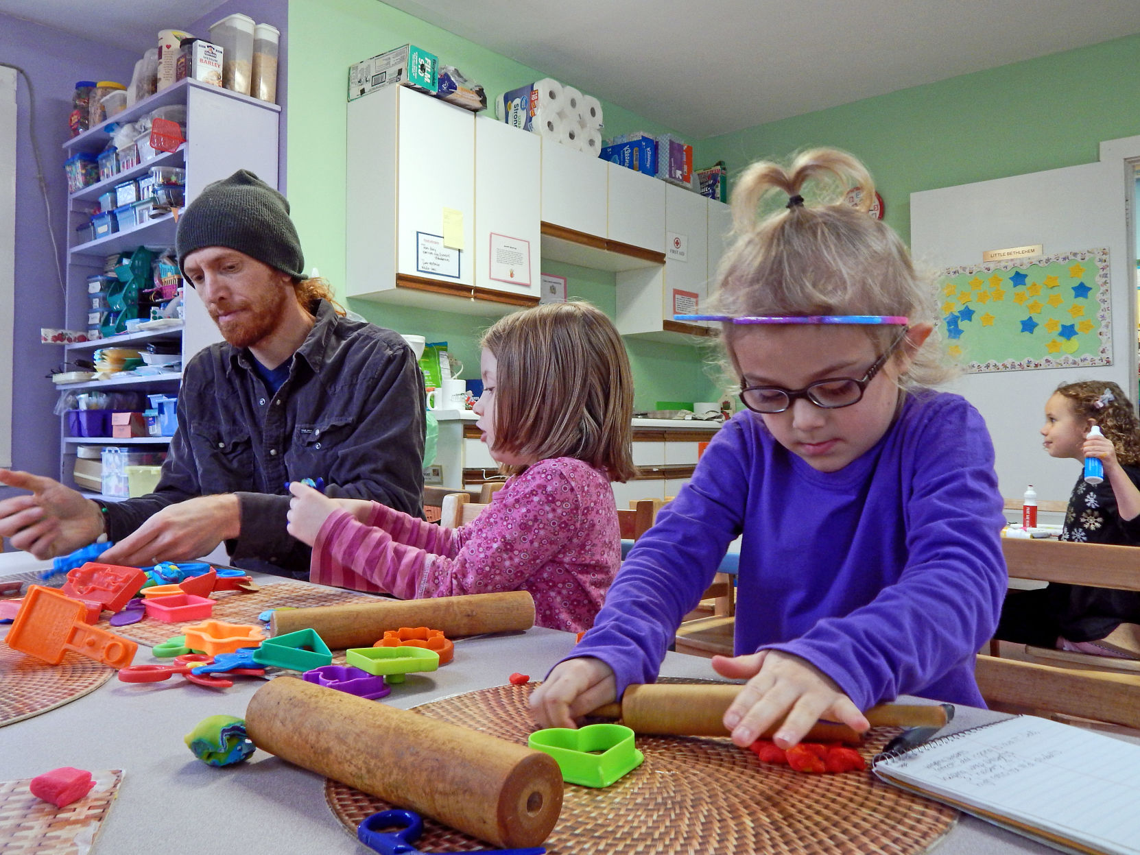 Zia Eisman and her dad Lael Eisman with student Frankie Caraher at Trumansburg Community Nursery School.